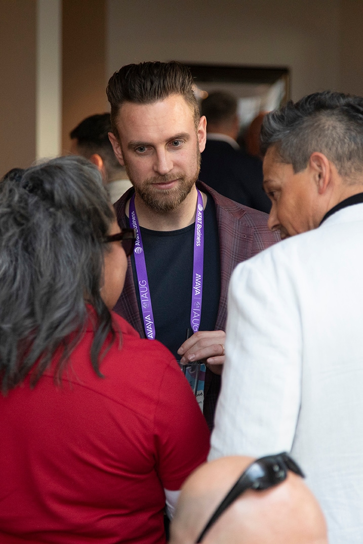 Portrait of a man wearing a purple lanyard